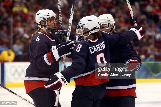 Caitlin Cahow of the United States celebrates scoring with teammates Angela Ruggiero and Karen Thatcher during the ice hockey women's semifinal game...