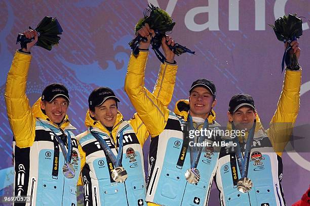 The German team receive the silver medal during the medal ceremony for the men's team ski jumping on day 11 of the Vancouver 2010 Winter Olympics at...