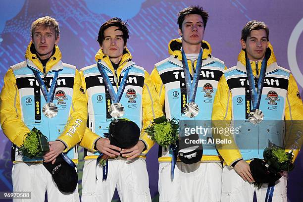 The German team receive the silver medal during the medal ceremony for the men's team ski jumping on day 11 of the Vancouver 2010 Winter Olympics at...