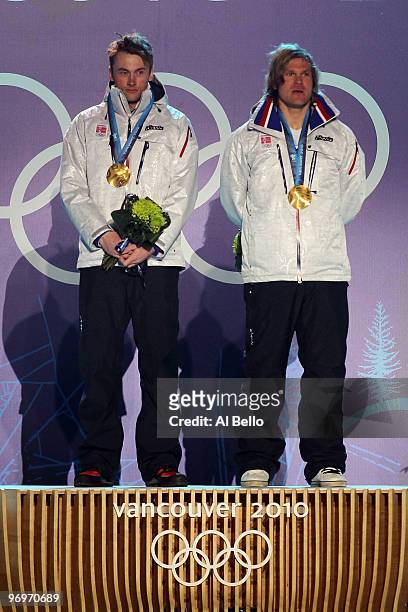 Petter Northug and Oeystein Pettersen of Norway receive the gold medal during the medal ceremony for the men's team sprint cross-country skiing on...