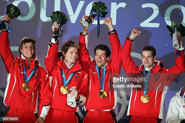 The Austrian team receive the gold medal during the medal ceremony for the men's team ski jumping on day 11 of the Vancouver 2010 Winter Olympics at...