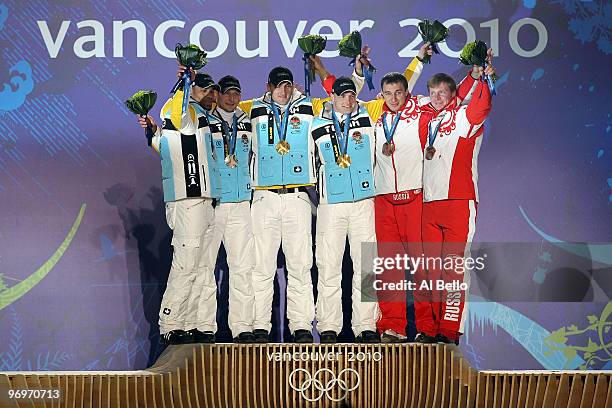 Richard Adjei and Thomas Florschuetz of Germany receive the silver medal, Kevin Kuske and Andre Lange of Germany receive the gold medal and Alexey...