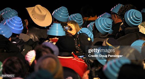 Fans watch devo perform at the medal ceremony on day 11 of the Vancouver 2010 Winter Olympics at Whistler Medals Plaza on February 22, 2010 in...