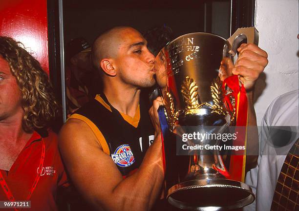 Andrew McLeod of the Crows holds up the premiership trophy after winning the 1998 AFL Grand Final between the St Kilda Saints and the Adelaide Crows...