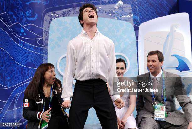 Tessa Virtue and Scott Moir of Canada celebrate after receiving their scores for the free dance portion of the Ice Dance competition on day 11 of the...