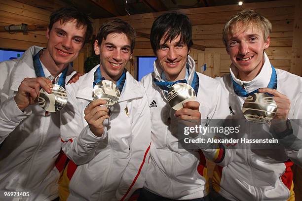 The German team of Andreas Wank, Michael Neumayer, Martin Schmitt and Michael Uhrmann pose with the silver medal for the men's team ski jumping on...