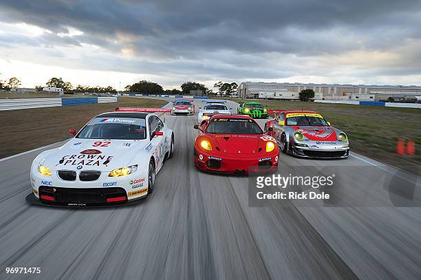 Dirk Muller of Germany drives the and Tommy Milner drives the BMW Rahal Letterman Racing BMW M3, Jorg Bermeister of Germany drives the and Seth...