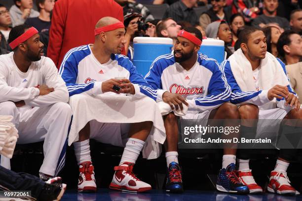 Bobby Brown, Drew Gooden, Baron Davis, and Eric Gordon of the Los Angeles Clipper sit on the bench during a game against the Charlotte Bobcats at...