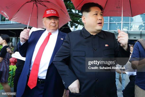 Kim Jong-un impersonator, Howard X and Donald Trump impersonator, Dennis Alan make an appearance at Merlion Park on June 8, 2018 in Singapore. The...