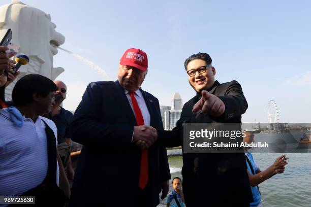 Kim Jong-un impersonator, Howard X and Donald Trump impersonator, Dennis Alan make an appearance at Merlion Park on June 8, 2018 in Singapore. The...