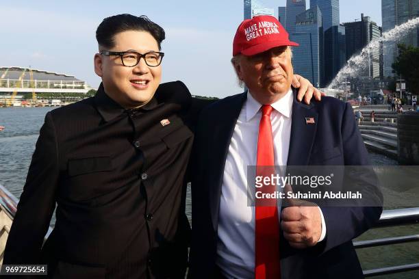 Kim Jong-un impersonator, Howard X and Donald Trump impersonator, Dennis Alan make an appearance at Merlion Park on June 8, 2018 in Singapore. The...
