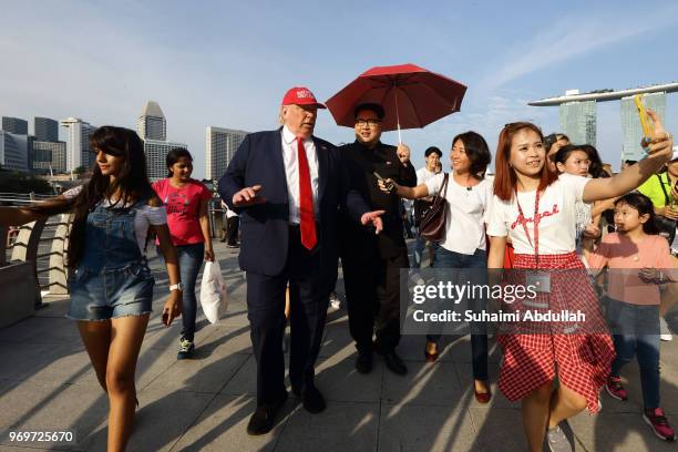 Kim Jong-un impersonator, Howard X and Donald Trump impersonator, Dennis Alan make an appearance at Merlion Park on June 8, 2018 in Singapore. The...