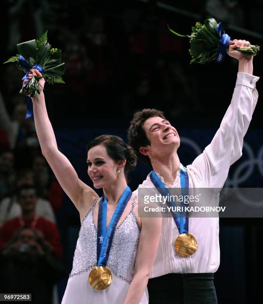 Gold medallists, Canada's Tessa Virtue and Scott Moir, celebrate on the podium during the medal ceremony after performing in the Ice Dance Free...