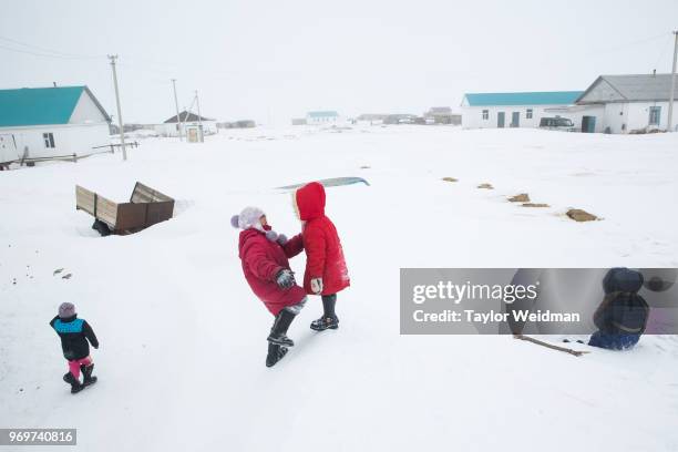 Children play on a snowdrift in Tastubek, Kazakhstan. The Aral Sea, once the fourth-largest lake in the world, started drying out and shrinking due...