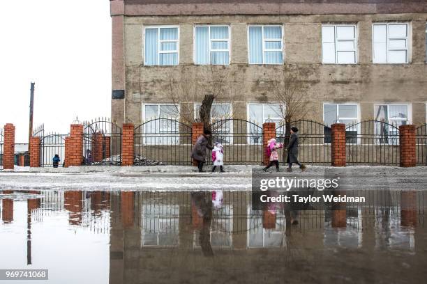 Children are picked up from a school in Aralsk, Kazakhstan. The Aral Sea, once the fourth-largest lake in the world, started drying out and shrinking...