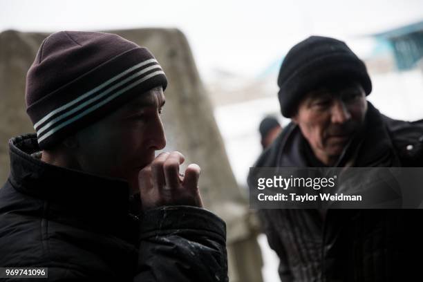 Worker takes a smoke break at a fish processing facility in Aralsk, Kazakhstan. The Aral Sea, once the fourth-largest lake in the world, started...