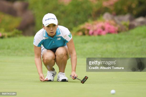 Chie Arimura of Japan lines up her putt on the 18th hole during the second round of the Suntory Ladies Open Golf Tournament at the Rokko Kokusai Golf...