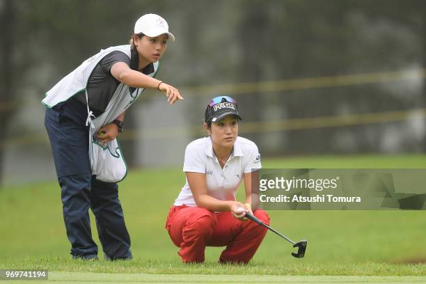 Asako Fujimoto of Japan lines up her putt on the 12th hole during the second round of the Suntory Ladies Open Golf Tournament at the Rokko Kokusai...