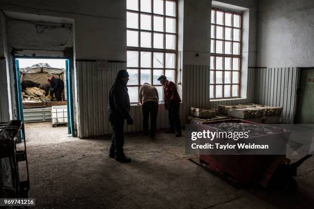 Bin of fish are weighed upon deliver to a fish processing facility in Aralsk, Kazakhstan. The Aral Sea, once the fourth-largest lake in the world,...