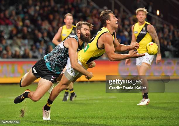 Alex Rance of the Tigers is tackled by Justin Westhoff of the Power during the round 12 AFL match between the Port Adelaide Power and the Richmond...