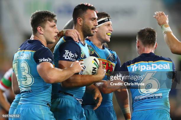 Ryan James of the Titans celebrates a try with team mates during the round 14 NRL match between the Gold Coast Titans and the South Sydney Rabbitohs...