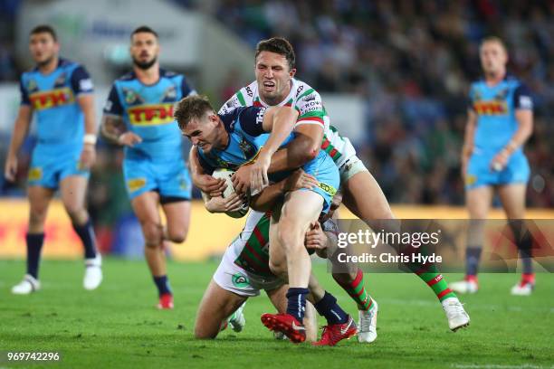 Alexander Brimson of the Titans is tackled during the round 14 NRL match between the Gold Coast Titans and the South Sydney Rabbitohs at Cbus Super...