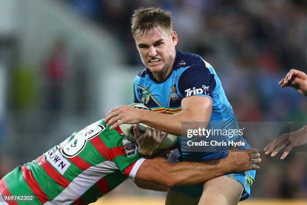 Alexander Brimson of the Titans is tackled during the round 14 NRL match between the Gold Coast Titans and the South Sydney Rabbitohs at Cbus Super...