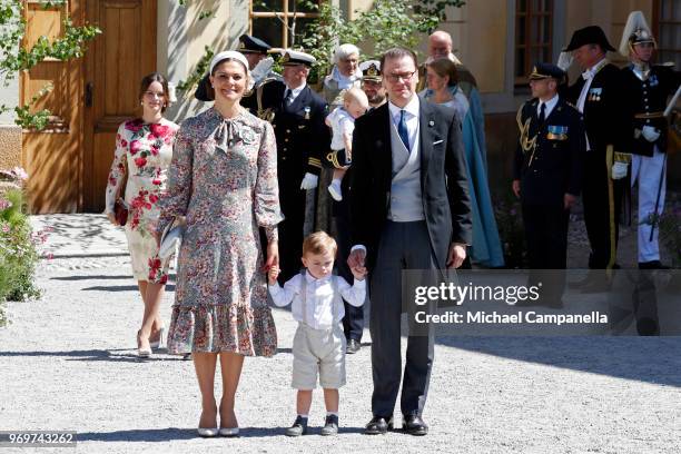 Crown Princess Victoria of Sweden, Prince Oscar of Sweden and Prince Daniel of Sweden pose after the christening of Princess Adrienne of Sweden at...