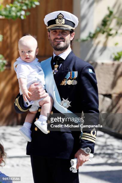 Prince Carl Phillip of Sweden holding Prince Gabriel of Sweden poses after the christening of Princess Adrienne of Sweden at Drottningholm Palace...