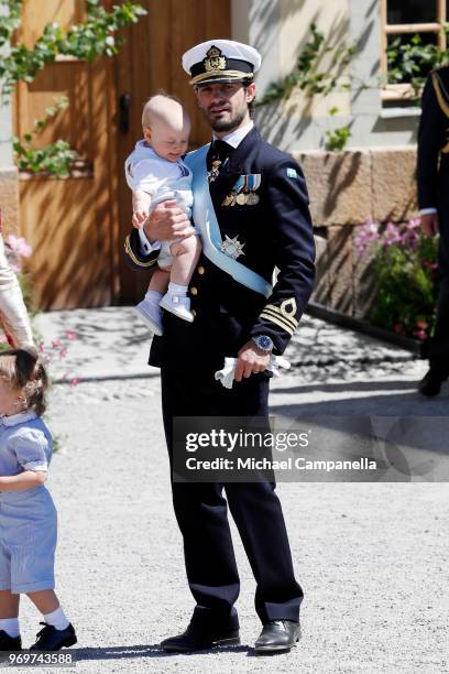 Prince Carl Phillip of Sweden holding Prince Gabriel of Sweden poses after the christening of Princess Adrienne of Sweden at Drottningholm Palace...