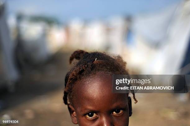 Hatian girl stands amid tents in a camp near Cite Soleil, a slum in Port-au-Prince on February 21, 2010. The earthquake that devastated Haiti on...