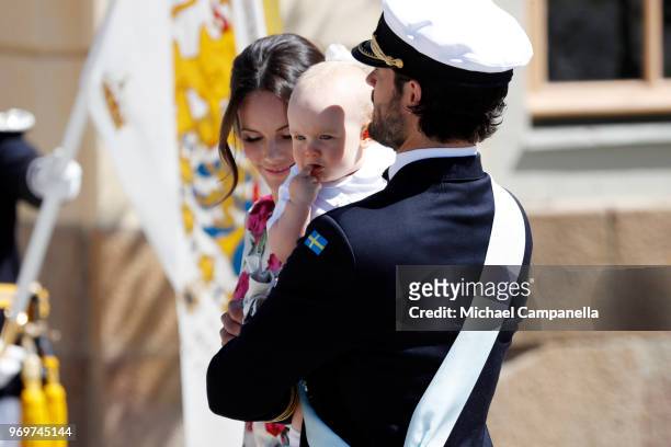 Princess Sofia of Sweden and Prince Carl Phillip of Sweden holding Prince Gabriel of Sweden pose after the christening of Princess Adrienne of Sweden...