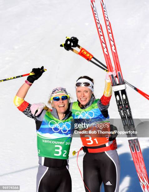 Claudia Nystad and Evi Sachenbacher-Stehle of Germany celebrate winning the gold medal in the cross country skiing ladies team sprint final on day 11...