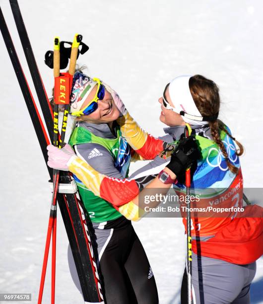 Claudia Nystad and Evi Sachenbacher-Stehle of Germany celebrate winning the gold medal in the cross country skiing ladies team sprint final on day 11...