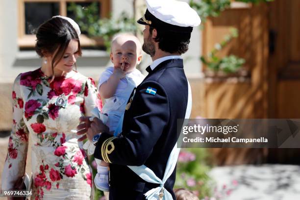 Princess Sofia of Sweden and Prince Carl Phillip of Sweden holding Prince Gabriel of Sweden pose after the christening of Princess Adrienne of Sweden...