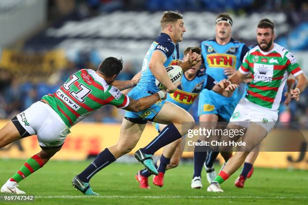 Max King of the Titans is tackled during the round 14 NRL match between the Gold Coast Titans and the South Sydney Rabbitohs at Cbus Super Stadium on...