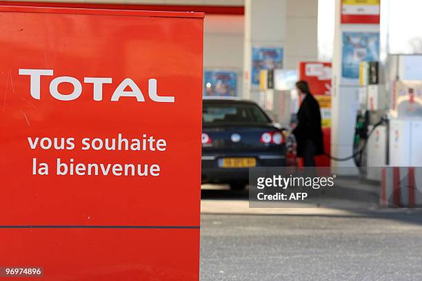 Man refuels his car at a gas station of French energy group Total on February 19, 2010 in Herouville-Saint-Clair, northwestern France. A call by...