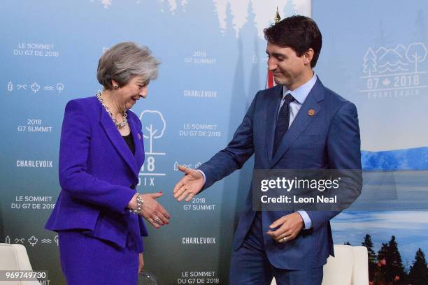 British Prime Minister Theresa May is greeted by Canadian Prime Minister on the first day of the G7 Summit, on 8 June, 2018 in La Malbaie, Canada....