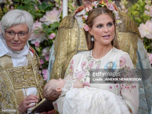 Officiant Archbishop Antje Jackelen , Princess Madeleine and her child Princess Adrienne of Sweden are pictured during Princess Adrienne's...