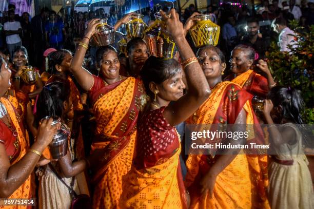 Fans of Bollywood actor Rajinikanth displaying body paint with a portrait of the actor as they dance on the first day of release of his new film...