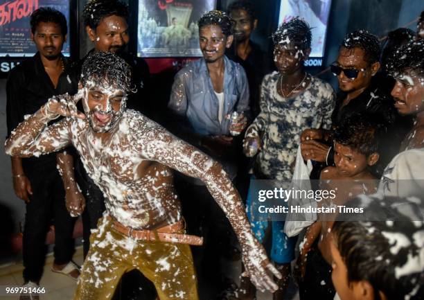 Fan display tickets of first show in front of Indian Bollywood star Rajinikanth body paint with a portrait of the actor on the first day of release...