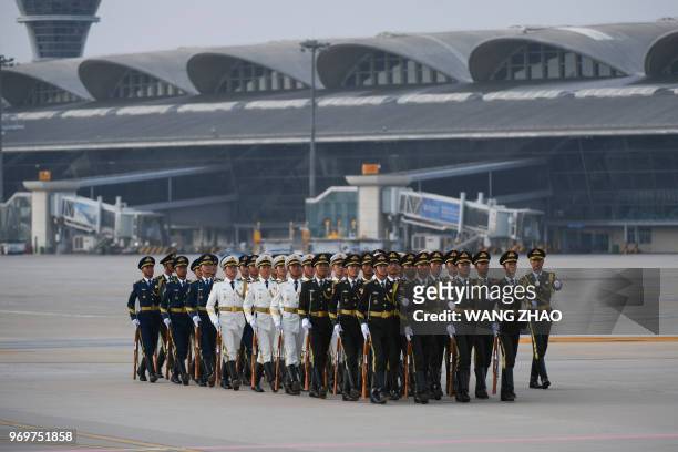 Chinese honour guards prepare for the arrival of Uzbekistan President Shavkat Mirziyoyev at Qingdao Liuting International Airport for the 18th...