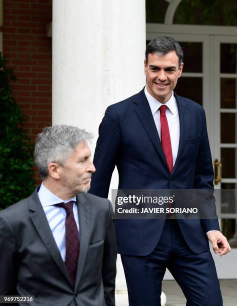 Spanish Prime Minister Pedro Sanchez looks at Spanish interior minister Fernando Grande-Marlaska prior to posing with the rest of new ministers for a...