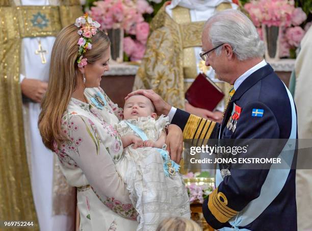 Princess Madeleine of Sweden, princess Adrienne of Sweden and king Carl Gustaf of Sweden are pictured during Princess Adrienne's christening ceremony...