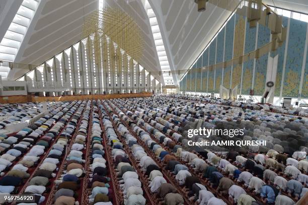 Pakistani Muslims offer prayers on the last Friday of the holy month of Ramadan at the grand Faisal Mosque in Islamabad on June 8, 2018. - Muslims...