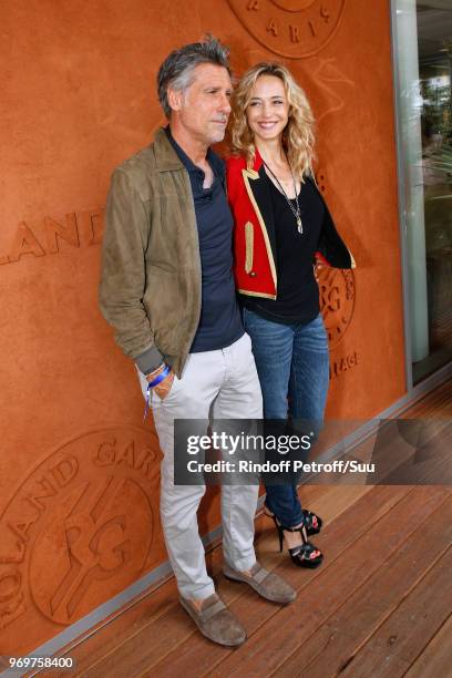 Fondator of Meetic, Marc Simoncini and his companion actress Helene de Fougerolles attend the 2018 French Open - Day Thirteen at Roland Garros on...