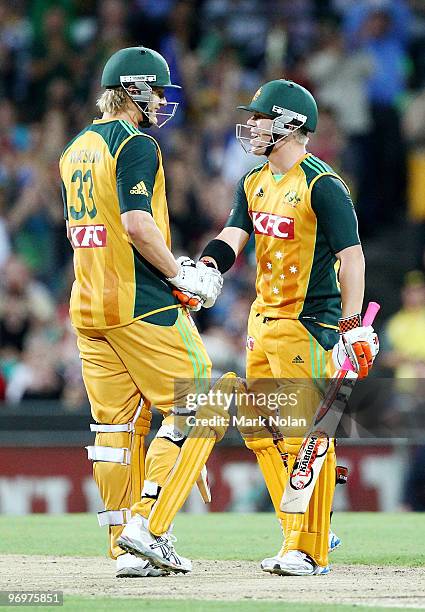 Shane Watson of Australia congratulates team mate David Warner after Warner scored a half century during the Twenty20 International match between...