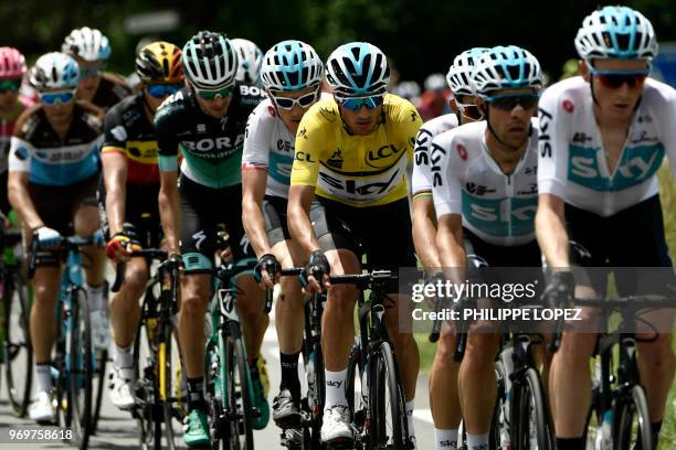 Italy's Gianni Moscon , wearing the overall leader's yellow jersey, rides at the lead of the pack with his Great Britain's Sky cycling team...