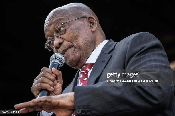 Former South African President Jacob Zuma gestures as he delivers a speech during a rally in his support outside the High Court, in Durban on June 8,...