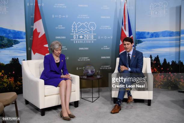 British Prime Minister Theresa May speaks with Canadian Prime Minister Justin Trudeau on the first day of the G7 Summit, on 8 June, 2018 in La...